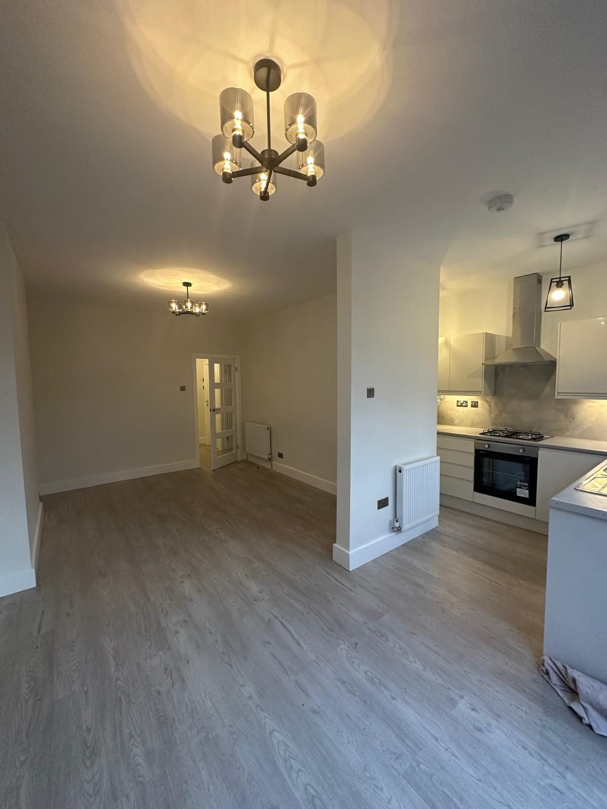 Open-plan living, dining and kitchen area in a two-bedroom Harrow property managed by FNJ Group
