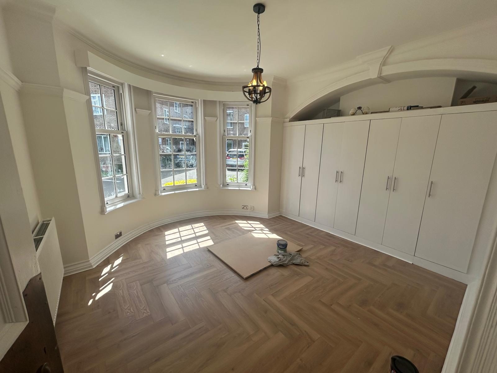 Bay-window bedroom with fitted wardrobes in a North West London property managed by FNJ Group