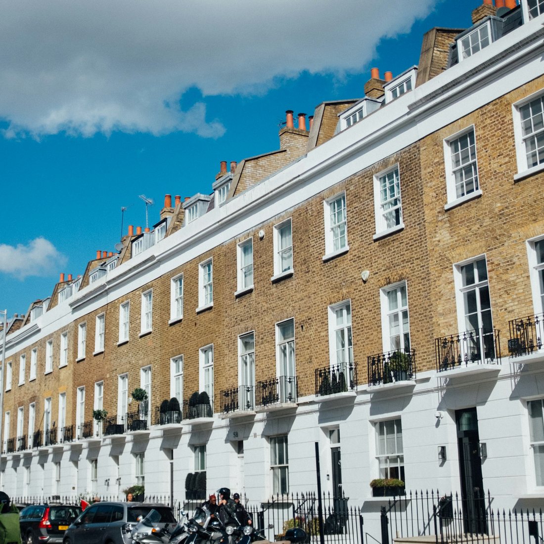 Traditional terraced houses under a blue sky — generic UK residential street photograph, not one of FNJ Group's own properties