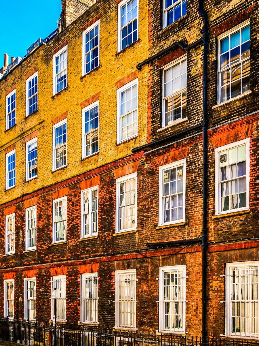 Row of brick London residential buildings with white-trimmed windows — generic exterior photograph, not one of FNJ Group's own properties